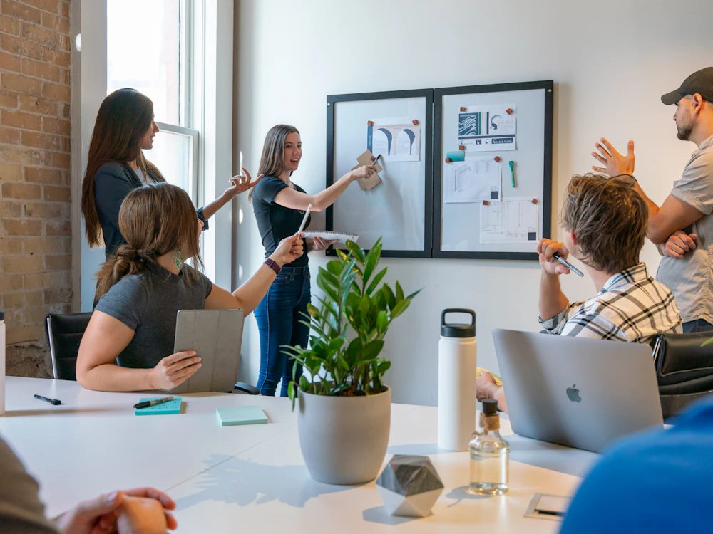 Business team discussing ideas around a meeting table