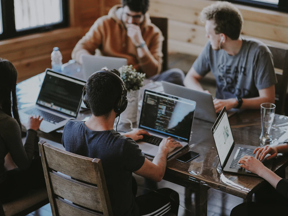 Small business team working together around a laptop